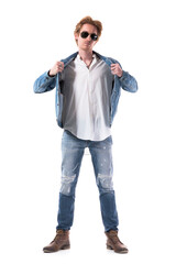 Confident young stylish man put on jean jacket wearing denim and getting dressed. Full body length isolated on white background. 