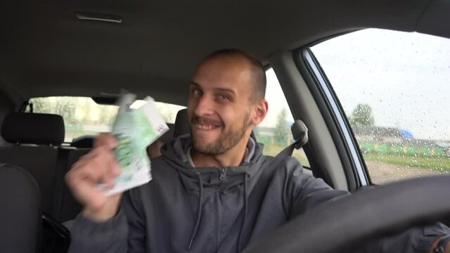 Happy driver with big money euro. Success. Concept on the business success, topic of lottery, winnings, slot machines.