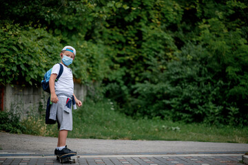 Caucasian boy riding a  skateboard, wearing a protective face mask 
