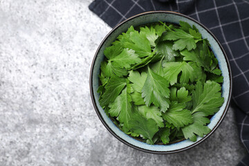 Fresh green parsley on grey table, top view. Space for text