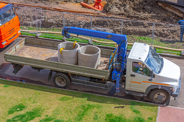 Truck mounted mobile crane, concrete sewer rings.