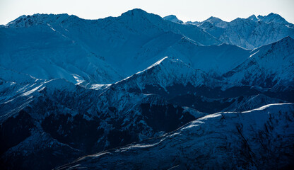 Winter landscape of snow mountain against blue sky in South island, New Zealand.