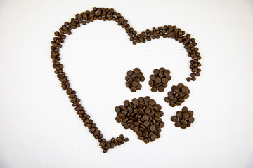 Dry dog kibble in a shape of a paw print and a heart