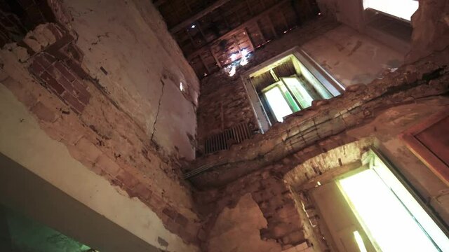 Abandoned house, wooden joists in the ceiling revealed by an earthquake. 4k