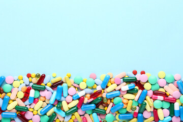 Colorful pills on blue background