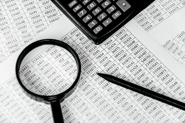 Business concept with magnifying glass, calculator and documents