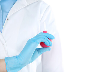 Doctor hand in glove holding pink enema on white background