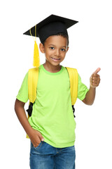 Young African American school boy in graduation cap with backpack on white background
