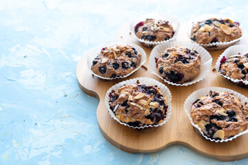 Homemade blueberry muffins on wooden board. light from the window