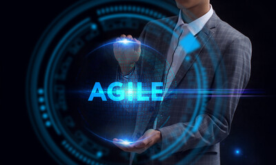 Business, Technology, Internet and network concept. Young businessman working on a virtual screen of the future and sees the inscription: Agile