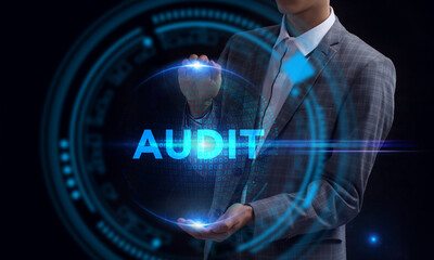 Business, Technology, Internet and network concept. Young businessman working on a virtual screen of the future and sees the inscription: Audit
