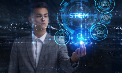 Business, Technology, Internet and network concept. Young businessman working on a virtual screen of the future and sees the inscription: STEM