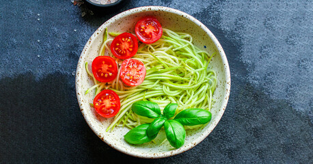 zucchini and tomato vegetables salad snack serving size. food background top view copy space healthy eating raw keto or paleo diet