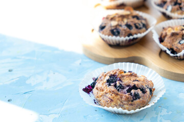 Homemade blueberry muffins on wooden board. light from the window