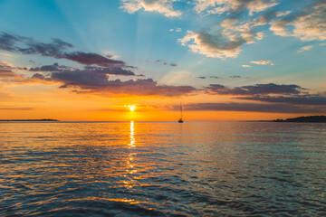 view of sail boat on sunset in bay. summer vacation