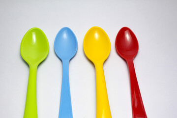colorful spoons and forks on white background.