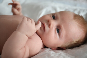 Cute little newborn baby on bed, closeup