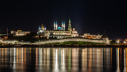 Kazan Kremlin summer night view from embankment of river with reflection of lights. Kazan, Russia