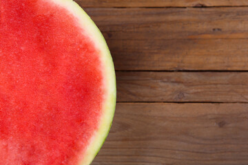the seedless watermelon - melon cut in half on the wooden table