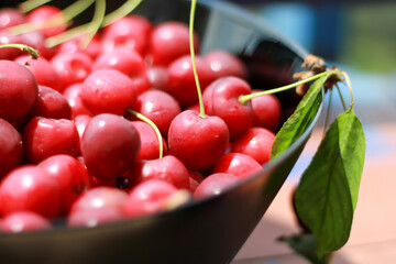 Fresh cherry on black plate on slate background