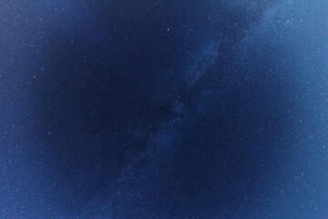 Comet NEOWISE in the night sky over the river, with the Milky Way and a tourist with a tent