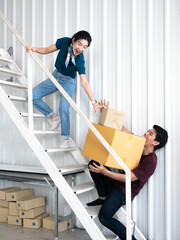 Asian couple young woman frightened and shocked man who carrying and holding cardboard and parcel...