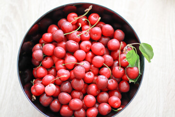Fresh cherry on black plate on slate background