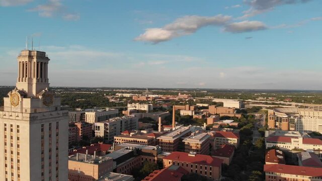Aerial Drone shot of the tower on UT campus that slowly pans towards the football stadium.