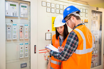 Professional industrial engineers operating in electricity substation
