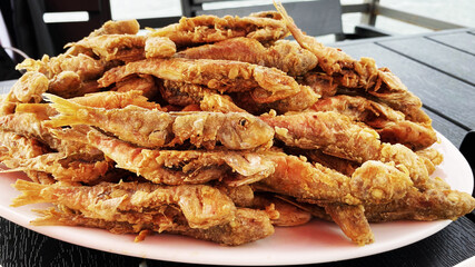 Deliciously fried red mullet fish on a plate