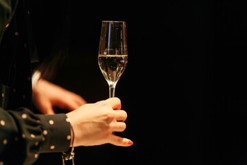 Woman holding a glass of white wine