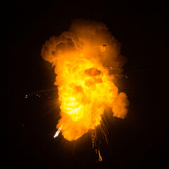Fiery bomb explosion with sparks isolated on black background. Bomb detonation. Textured photo of fire and  sparks