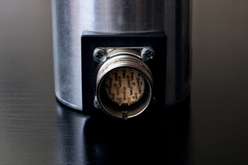 Metal encoder on a black wooden table