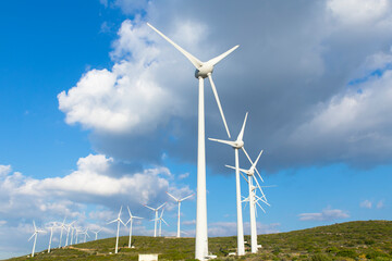 Scenic view of windmill farm on sunny spring day 