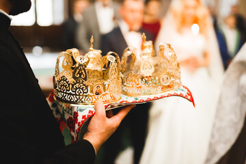 Fototapeta na wymiar Golden crowns lying on the table in church