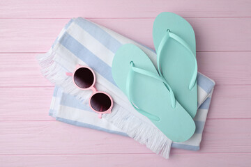 Beach objects on pink wooden background, flat lay