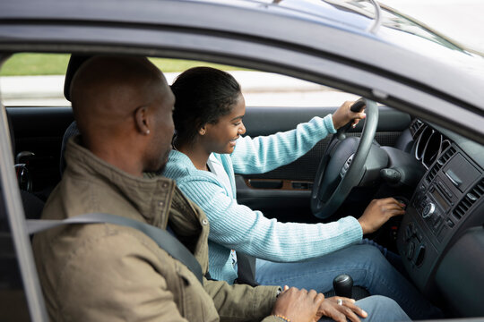 Father Teaching Teen Daughter To Drive Car