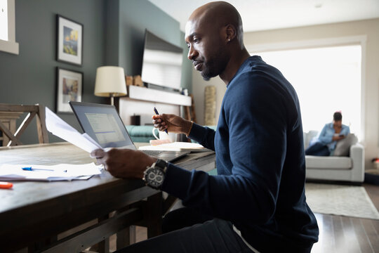 Focused Man Working From Home At Laptop