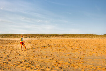 Woman flying kite on beach