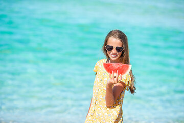 Adorable little girl have fun at tropical beach during vacation