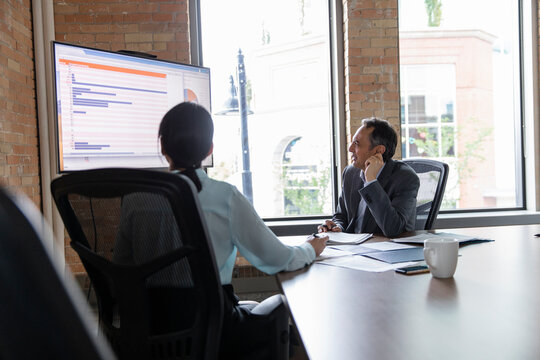 Business People Reviewing Data In Conference Room Meeting