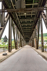 old iron bridge spans river Moselle, bridge is called Canon bridge and serves sicne the 17th century for trains and cars