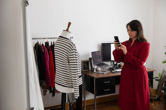 Woman Photographing Clothing In Home Studio