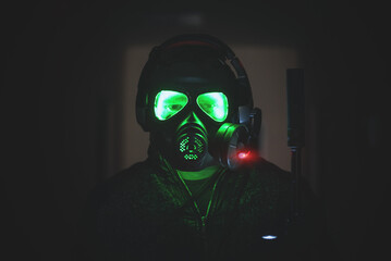 Futuristic soldier with a rifle in a gas mask.