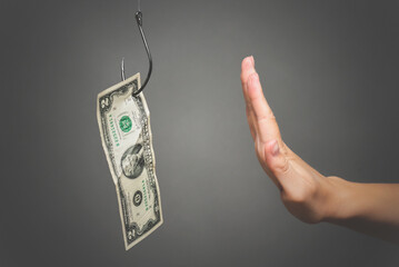 Woman hand is showing a stop gesture by her hand close up. Refusal to bribe concept.