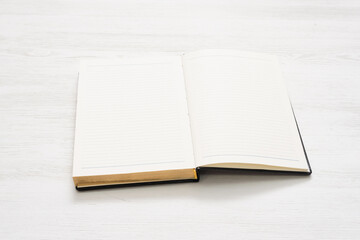 Blank page open book on the white table background.