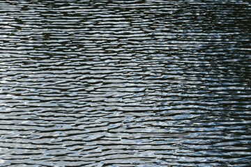 Ripples on natural dark water surface