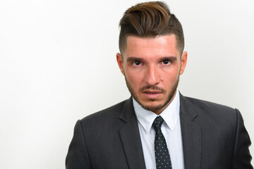 Portrait of handsome bearded Hispanic businessman in suit