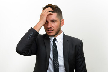 Portrait of handsome bearded Hispanic businessman in suit