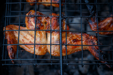 ruddy chicken wings are fried on the grill